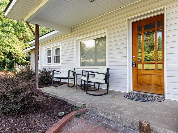 Nice covered front porch with included rocking chairs and table.