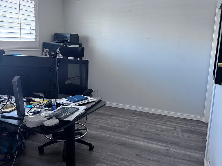 Bedroom #2 - Currently used as a home office. This room is 10x12, has a ceiling fan/light and shutters looking out to the front yard.