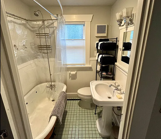 bathroom with tile floor and original claw foot tub