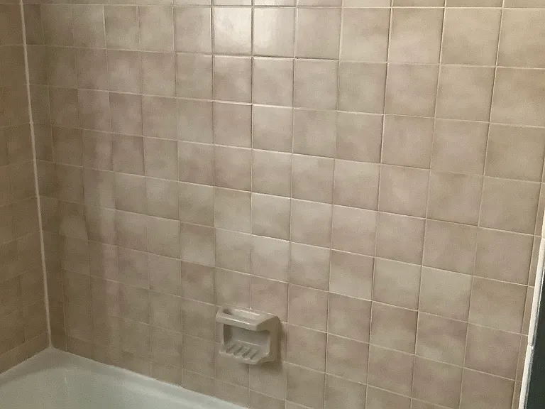 East bedroom has updated tile tub shower