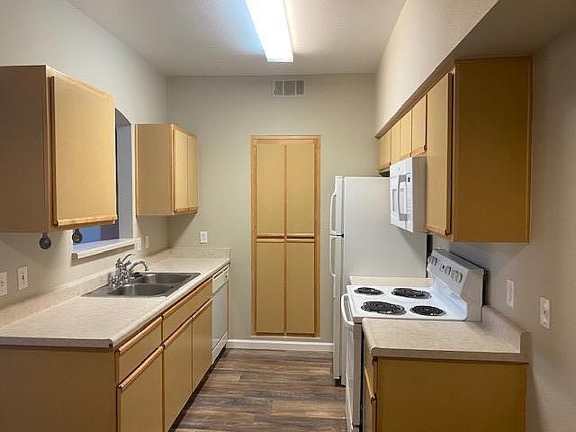 Kitchen: Spacious, New Flooring, New Paint, New Microwave, Storage Pantry, Pass-thru w/ dining area, open to Living Room