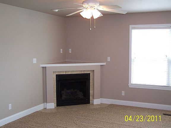 Living room with gas fireplace and fan