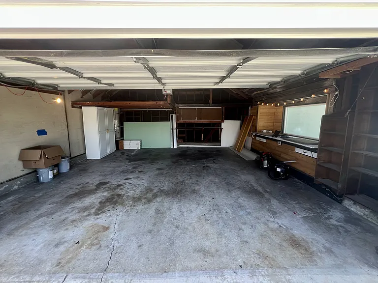 Two car garage with workbench and storage spaces
