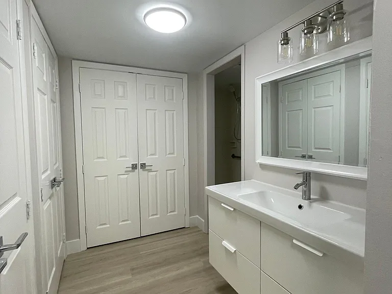 Master bath dressing area with new vanity and custom closet storage