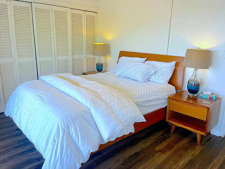This view of the primary bedroom shows the ample storage space in the full-size closet.