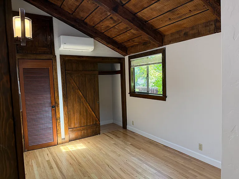 Bedroom #3 features wooden valuted ceiling, skylight, one window and 2 closets with a split AC cooling unit.
