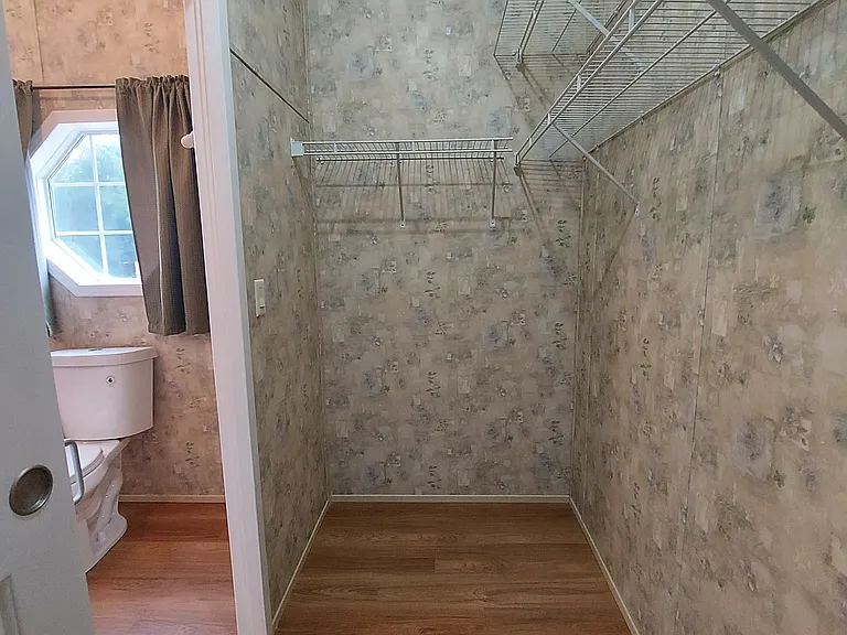 Back Master Suite closet has 14' of closet rod and double wire shelves. Sliding doors make all the clothes hanging space available, and closet lights make the space useful.