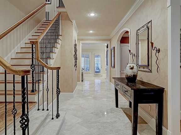 The expansive entry opens to a formal living room, formal dining room, and leads to the open kitchen/family/breakfast areas.