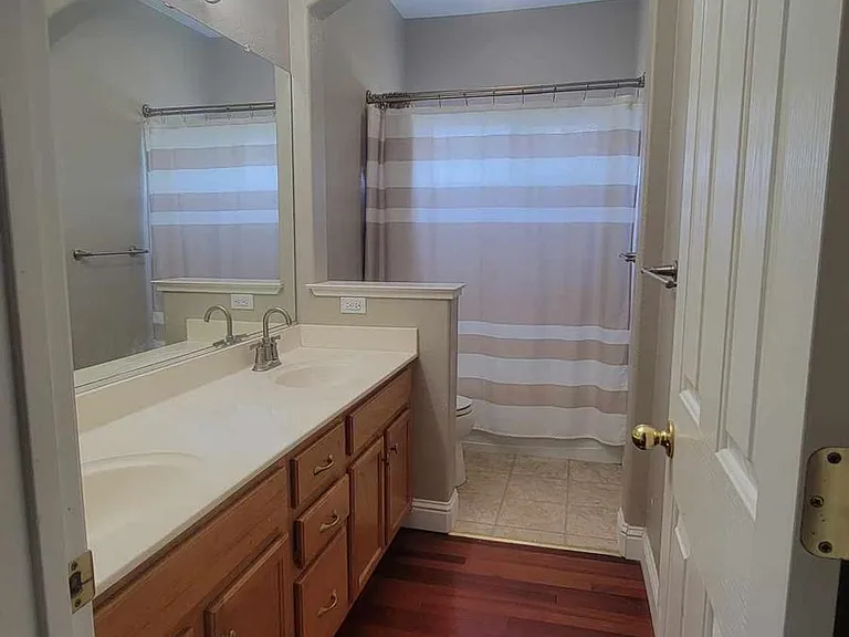 Full 3rd bathroom, upstairs, has shower/tub, toilet, and two sinks