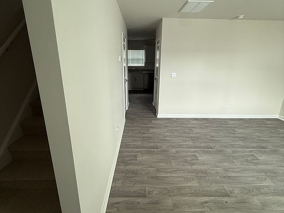 View from front door. Left: Stairs. Right: Living Room.