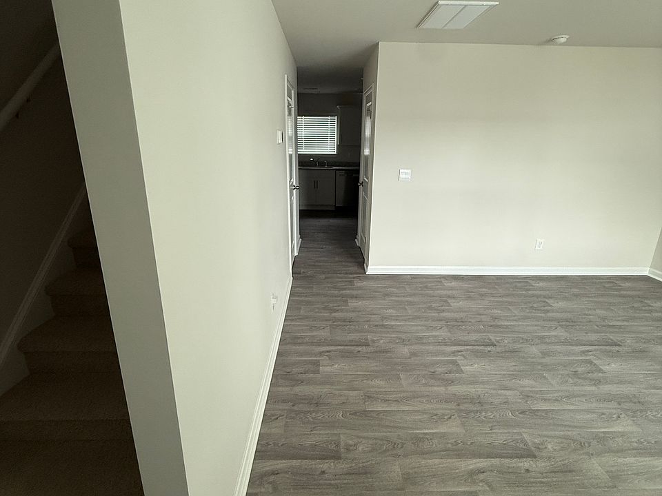 View from front door. Left: Stairs. Right: Living Room.