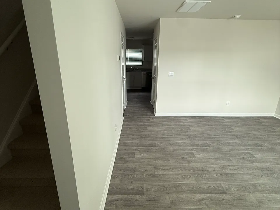 View from front door. Left: Stairs. Right: Living Room.