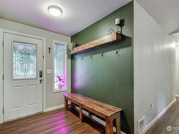 As you enter the home, you will find a new front door and convenient area for coats and shoes.>