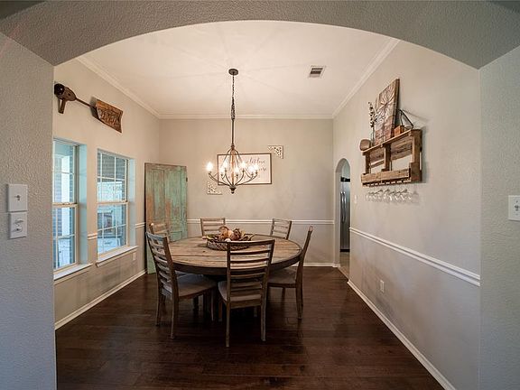 Gorgeous formal dining with access to the kitchen! You will love the light fixtures in both dining spaces!
