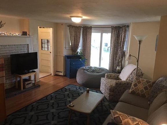 Cozy living room with fire place and NEW slider out to priva
