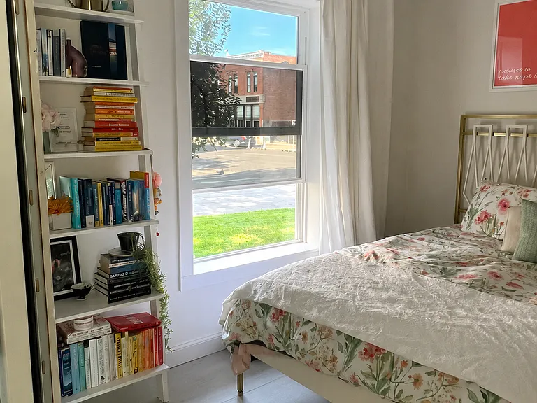 Bright, serene bedroom with oversized windows, abundant natural light, custom details, and a thoughtfully designed, comfortable layout.