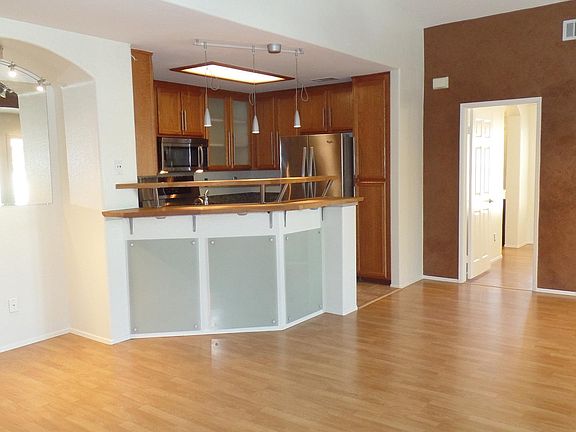 living room, kitchen and doorway to bedroom.