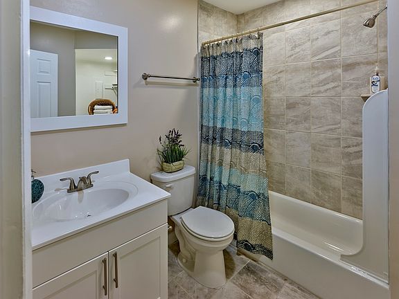 Enjoy a clean, modern bathroom at Haynes Run Apartments featuring neutral tile, sleek fixtures, and updated design elements.
