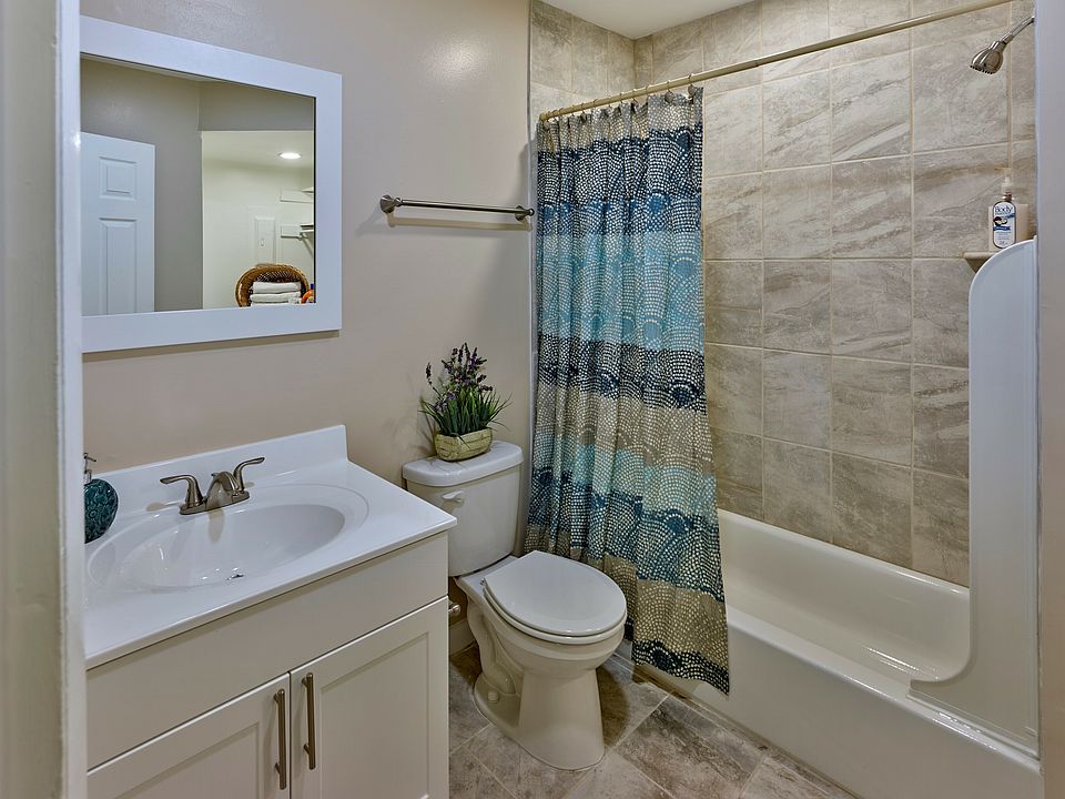 Enjoy a clean, modern bathroom at Haynes Run Apartments featuring neutral tile, sleek fixtures, and updated design elements.