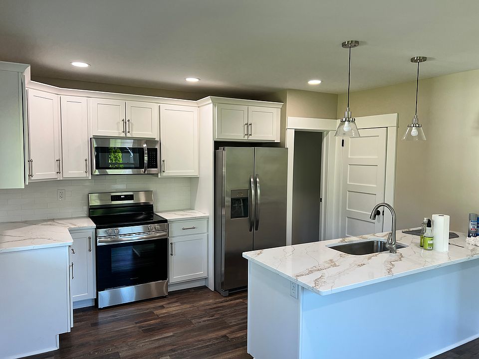 a great open kitchen dining area leads into the large living room. 2 pantry/ storage areas in this kitchen! All new cabinets, new oven, microwave, frig w ice maker. bright recessed lighting