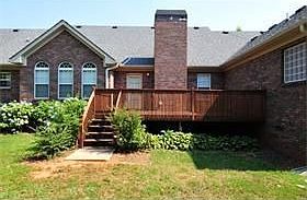 back of all brick ranch home