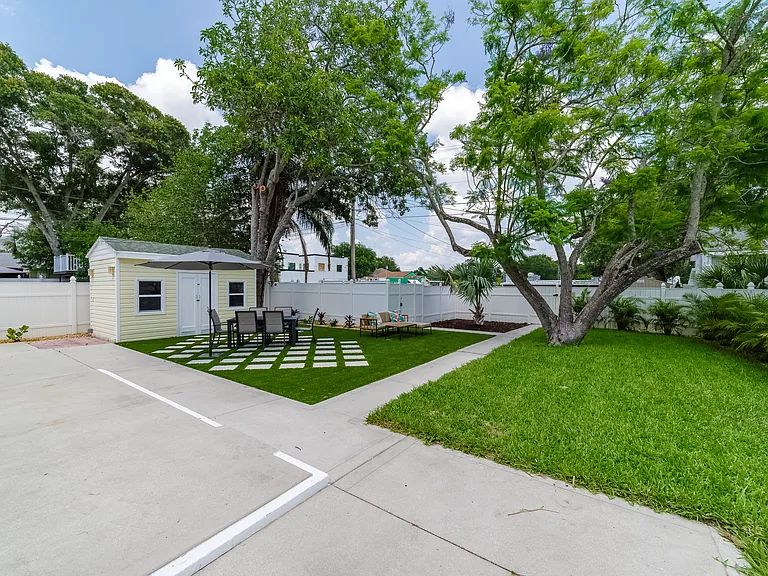 Spacious shared backyard with a dining table and comfortable seating area.