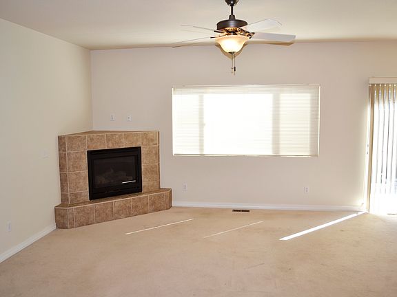 Large living room with fireplace in the corner.