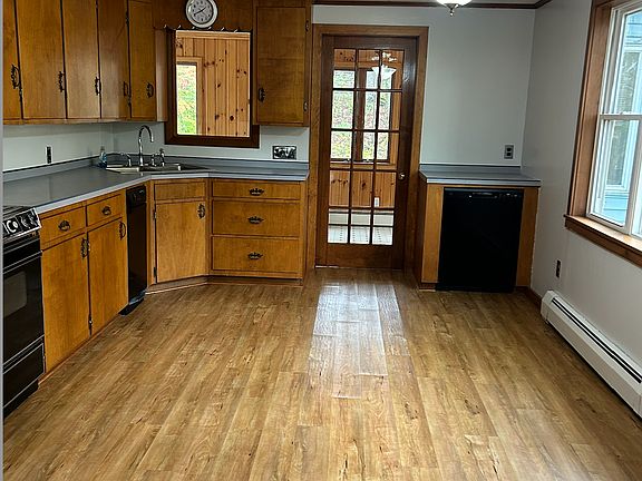Kitchen with heated sunroom and laundry.