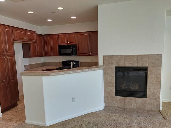 View from Living Room toward Kitchen with gas fireplace (turns on with a light switch -- no messy logs and lighters)
