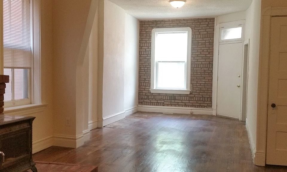 Living room view to front door - refinished hardwood floors,