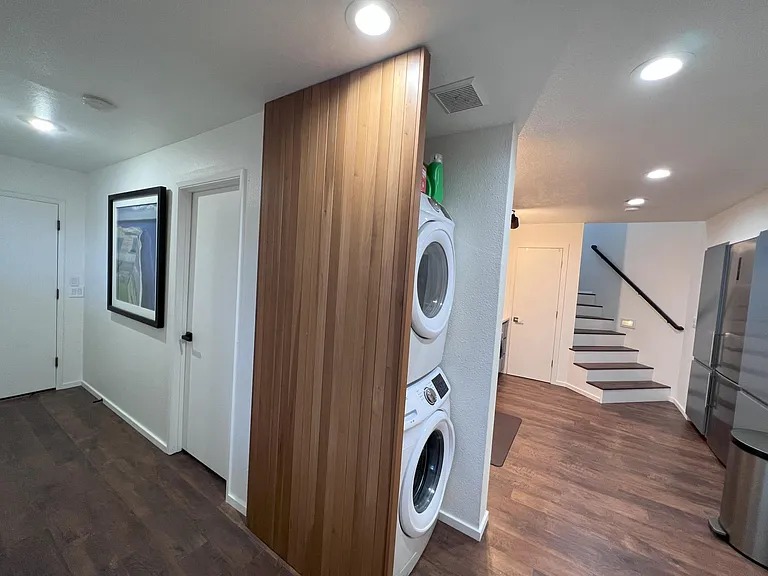 Walking past bedroom 2 to the in-unit washer and dryer