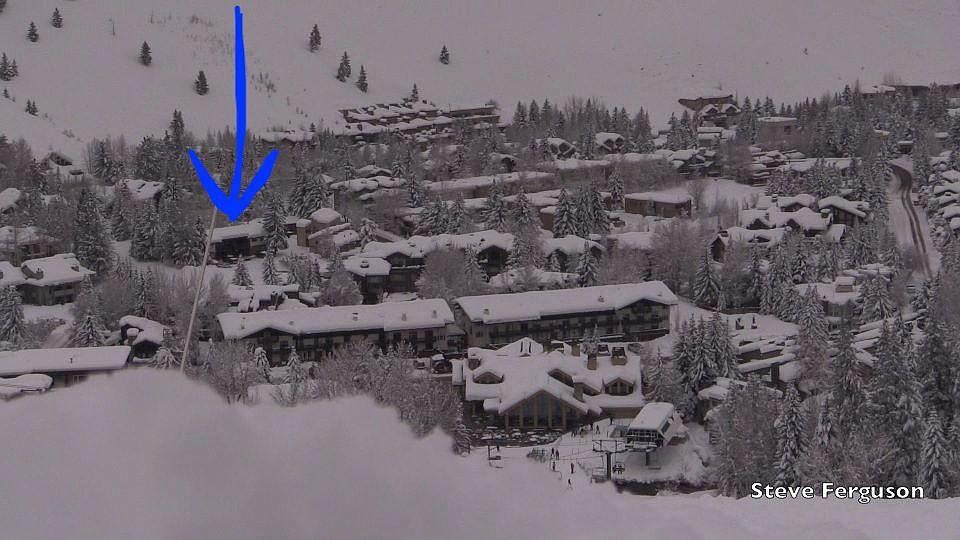 View of Warm Sprigs Day Lodge and lifts from the bottom of Flying Squirrel. Arrow points to location of condominium complex where property is located.