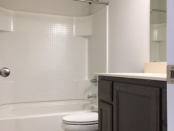 Secondary bathroom, with beautiful premium tile, cabinets and marble countertop.