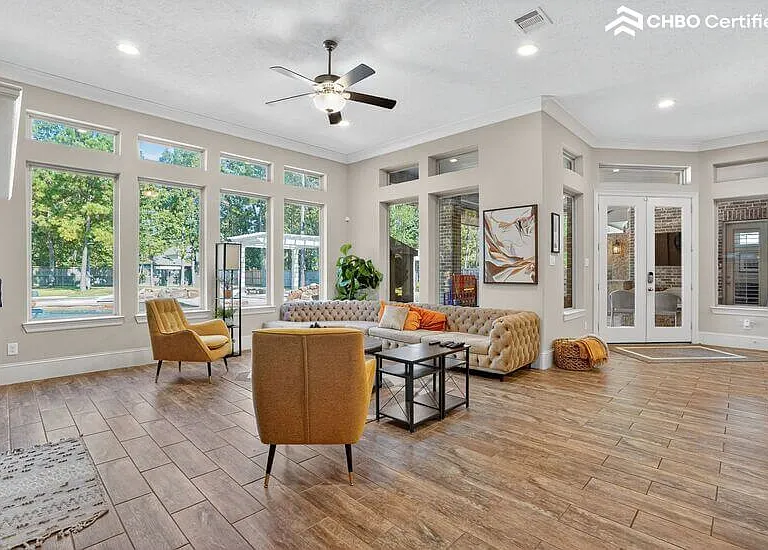 Sunlit living room with backyard views