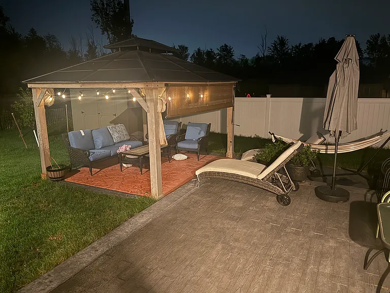 Gazebo with sunshade and string lights