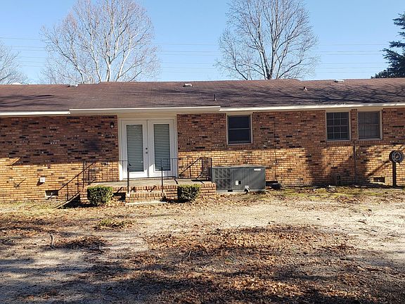 Backyard view of rental property, large fenced yard and deck/patio for entertainment.