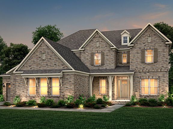 Hampton Exterior 18 features brick, covered front porch and 3 car sideload garage