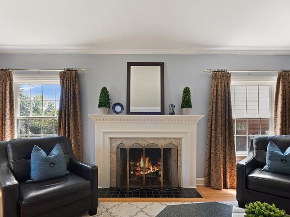 Intricately-Carved White Wood Mantel and Marble Surround Fireplace
