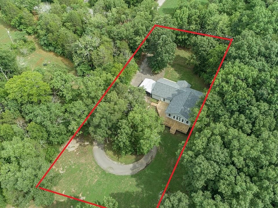 Property area in red. Circle drive in backyard. Top of picture is the road frontage.