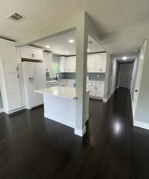 Open-concept kitchen that overlooks the living room and includes a dedicated breakfast area.