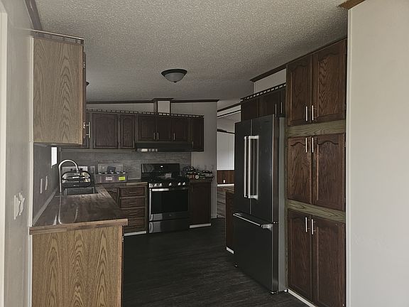 Lare kitchen with plenty of cupboard space for storage. Brand new stainless-steel sink and appliances (Fridge, stove, range hood, dishwasher.) New backsplash and light fixtures.