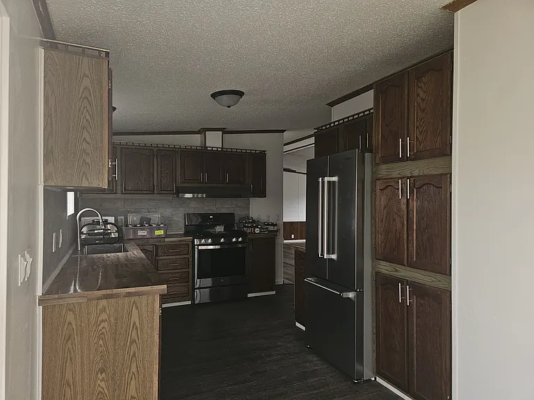 Lare kitchen with plenty of cupboard space for storage. Brand new stainless-steel sink and appliances (Fridge, stove, range hood, dishwasher.) New backsplash and light fixtures.