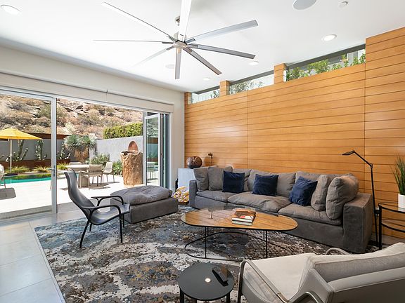 The great room with beautiful, contemporary furniture and a view to the backyard.