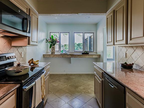 Kitchen has a pass through bar to the private back patio.