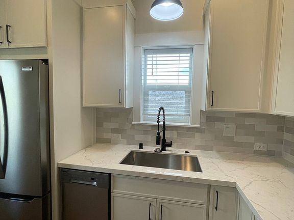 Undermount stainless sink with pull down faucet, garbage disposal and built in stainless dishwasher