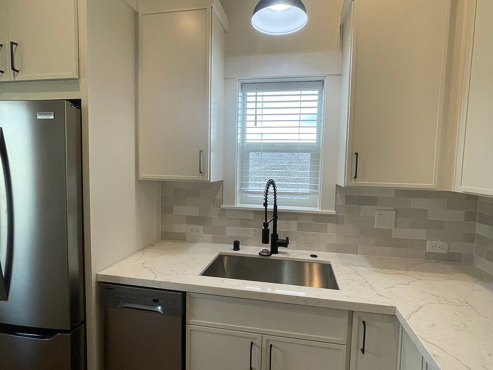 Undermount stainless sink with pull down faucet, garbage disposal and built in stainless dishwasher