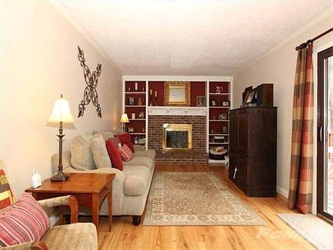 Crown moldings, laminate flooring a nd a woodburning fireplace highlights the family room with newly added bookcases.  Walk out to the two tiered decking & enjoy the   yard.
