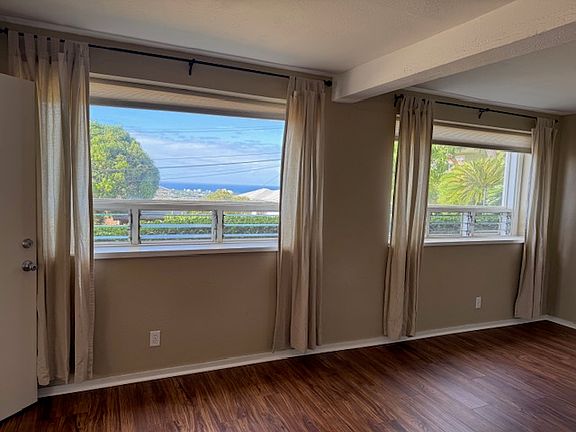 Large picture windows with ocean view from living room