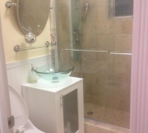 Renovated travertine bathroom with spa shower head