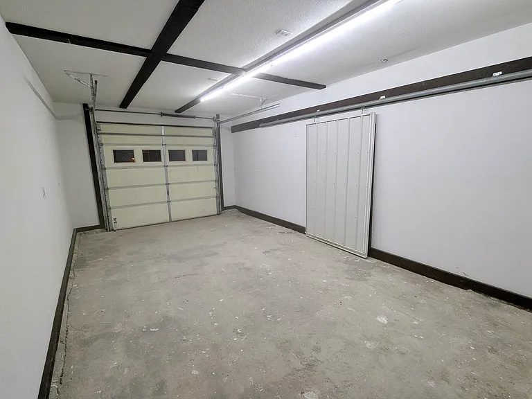 Oversized garage - 23x13' with 9' ceiling. Overhead door is 8.5' wide and 8' high. Includes automatic garage door opener.